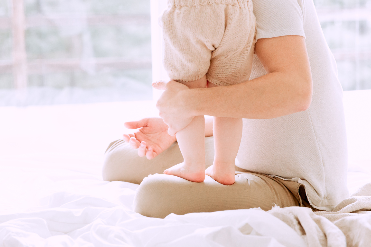 Baby Standing On Her Father's Lap