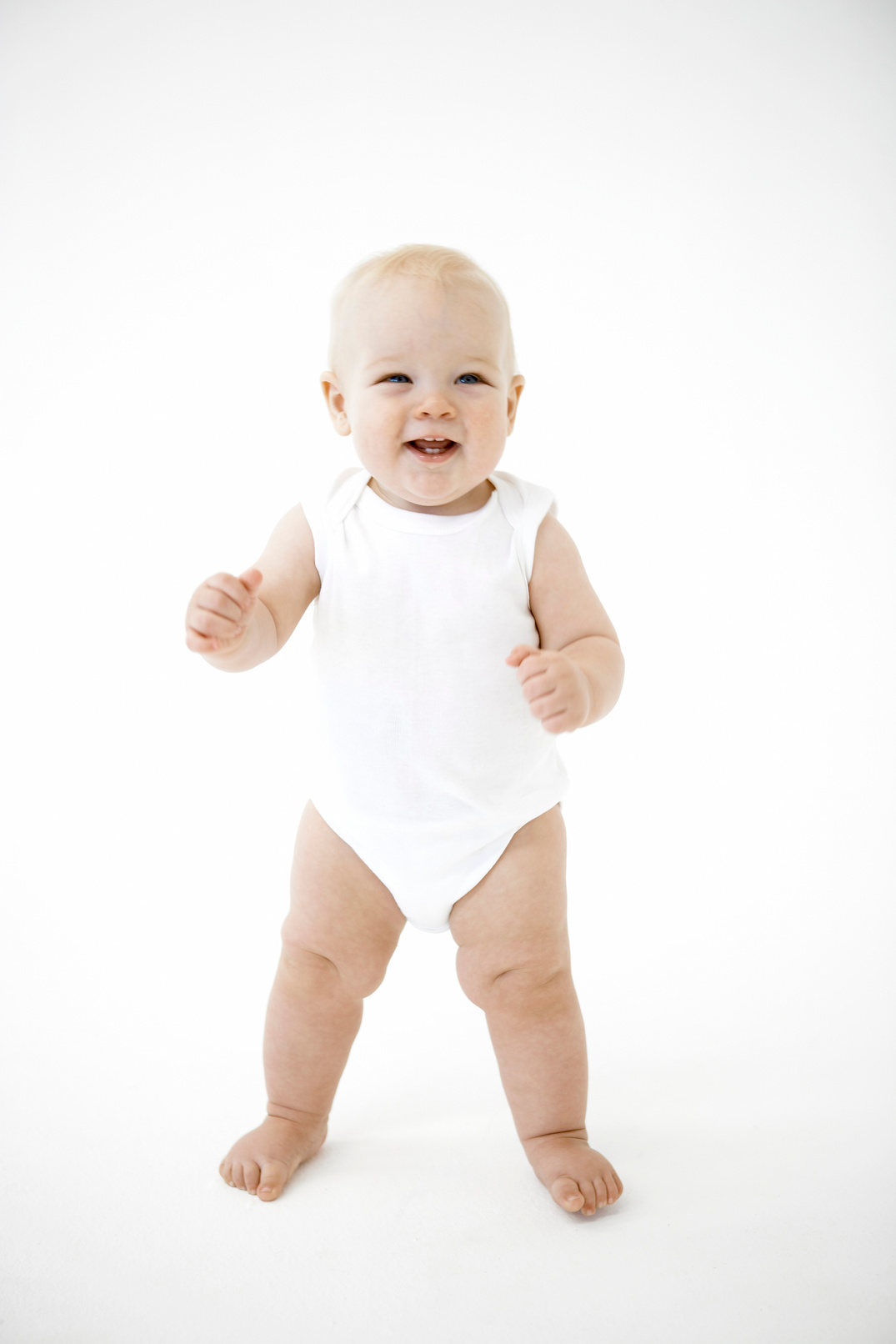 Baby standing and smiling